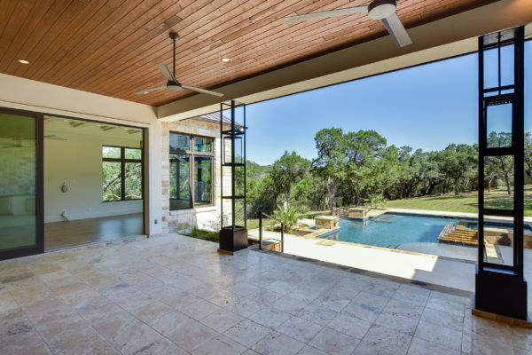 Covered Patio and Outdoor Kitchen Open to Luxury Pool