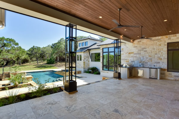 Outdoor Kitchen View of Mixed Limestone House in Cordillera Ranch